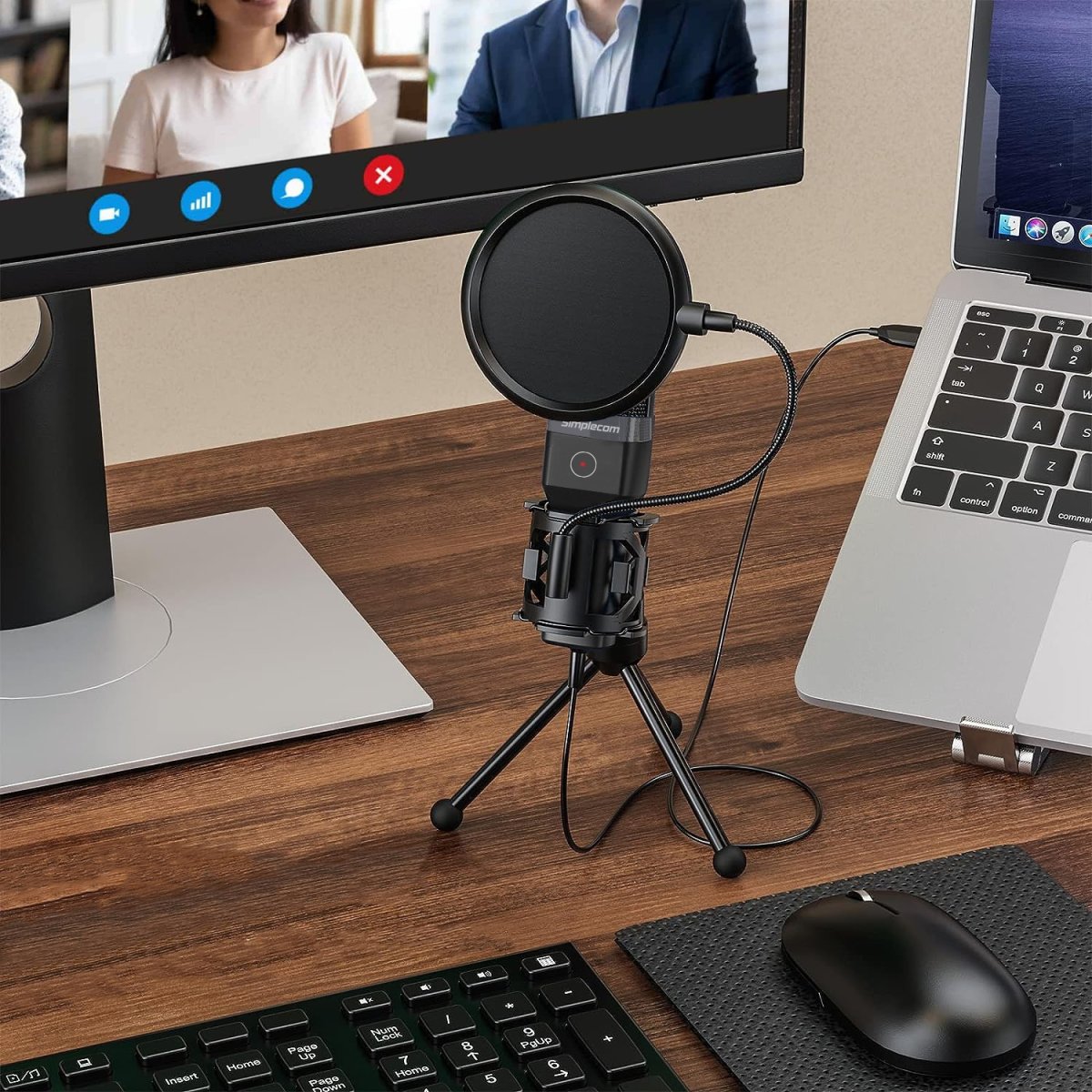 Simplecom UM650 USB condenser microphone on a desk tripod next to a laptop and mouse